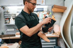 Holding prosthesis., Technician working in modern laboratory photo