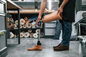 Prosthesis ,on the floor. Technician working in modern laboratory photo