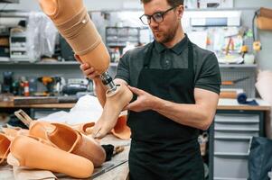 Technician, working with prosthesis, in modern laboratory photo