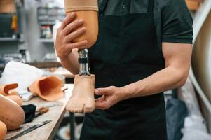 Close up view... Technician holding prosthesis in hands photo