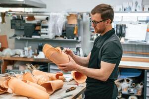 Using marker t,o draw the line. Technician working with prosthesis in modern laboratory photo