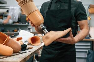 Close ,up view. Technician holding prosthesis in hands photo