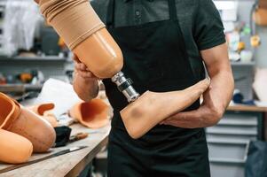 Close up ,view. Technician ,holding prosthesis in hands photo