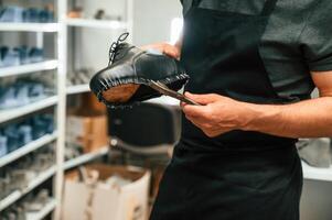 With shoe ,for prosthesis. Technician working in modern laboratory photo
