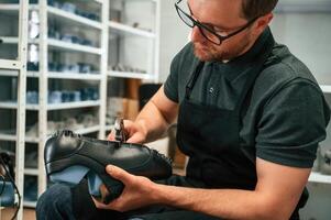 With ,shoe for prosthesis. Technician working in modern laboratory photo