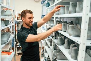 Raw shoe, parts for the prosthesis. Man is choosing size photo