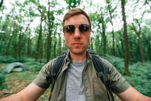 Selfie of tourist that is in summer forest. Conception of exploration and leisure photo