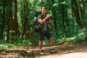 Tourist, in ,summer forest. Conception of exploration and leisure photo