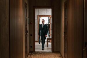 Front ,view, in the, appartment. Handsome businessman is indoors in the hotel room photo