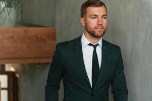 Front ,view, in the appartment. .Handsome businessman is indoors in the hotel room photo