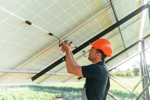 Fixes, the, wires. Man is doing operating and maintenance in solar power plant photo