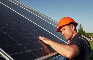 Man is ,doing operating and maintenance in solar power plant photo