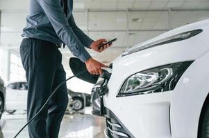 Close up view of man, that, is with electrical car photo