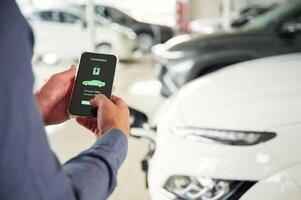 Information, of charging, process. Close up view of man that is with electrical car photo