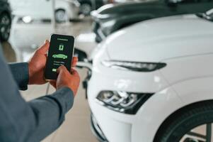 Information of charging, process. Close ,up view of man that is with electrical car photo