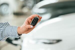 Close, up view of woman, that is with electric car photo