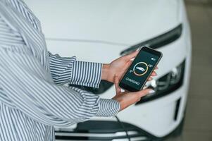 Close, up view of woman that is with ,electric car photo