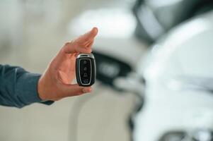 Close up view of man that is with electrical car photo