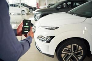 Information, of charging process. Close up view of man that is with electrical car photo