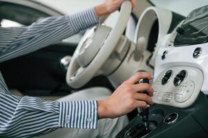 Driving the automobile.. Close up view of woman that is with electric car photo