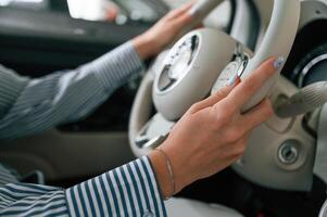 Driving ,the automobile.. Close up view of woman that is with electric car photo