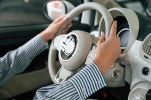 Driving, the automobile. Close up view of woman that is with electric car photo