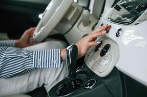 Front ,panel of automobile, driving. Close up view of woman that is with electric car photo