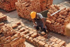 Top, view. Handsome Indian man is on the construction site photo