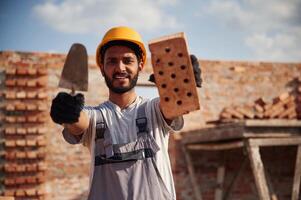 Cheerful and, handsome, Indian man is on the construction site photo