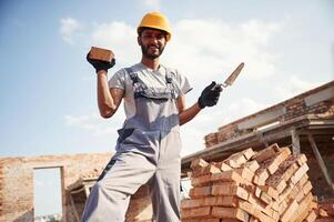 Cheerful, and ,handsome Indian man is on the construction site photo