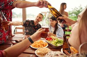 Doing, cheers.. Group of people are with beer in hands having good time photo