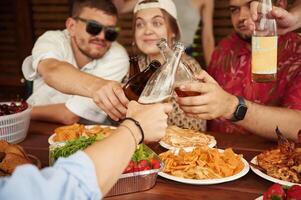 Doing cheers. Group, of people are with beer in hands having good time photo