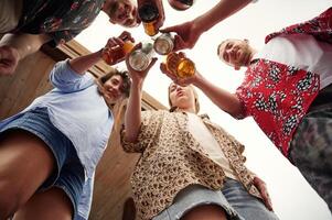 View from below.. Group of people are with beer in hands having good time photo
