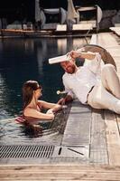 Man with woman is in the pool together photo