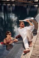 Man, with woman is in the, pool ,together photo