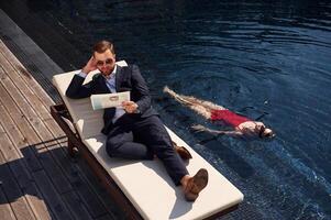 Man with woman is ,in ,the pool together photo