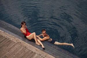 Vacation time, top, view.. Man with woman is in the pool together photo