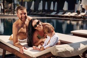 Conception of vacation. Happy family ,of ,father, mother and son are in the pool photo