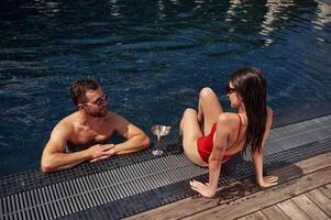 Man ,with, woman is in the pool together photo