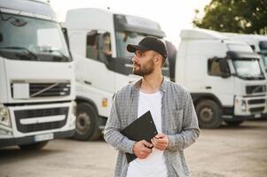 Manager, is, with notepad. Young truck driver in casual clothes photo