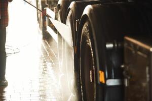 Man is washing the big vehicle indoors., Close up view photo