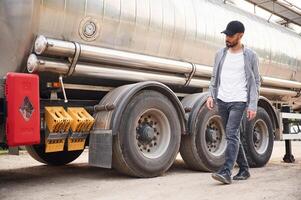 Checking the, vehicle condition.. Young, truck driver in casual clothes photo