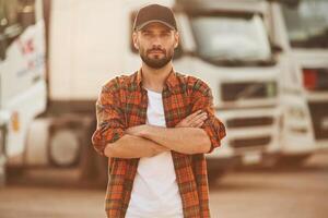 Arms ,crossed, standing. ,Young truck driver in casual clothes photo