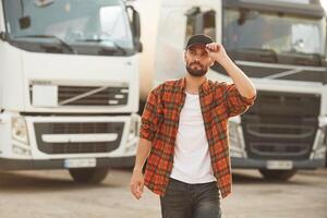 Brigh,t sunny d,ay. Young truck driver in casual clothes photo