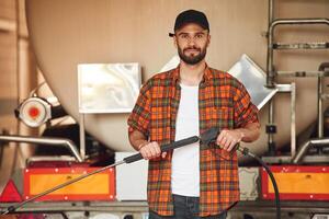 Process ,of washing, the vehicle. Young truck driver in casual clothes photo