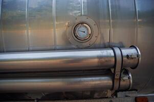 Close up view of fuel tanker with temperature check device photo