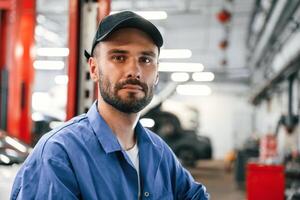 Portrait ,of, auto mechanic that is in garage. Repair service photo