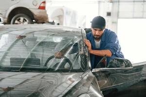 Moving ,the dirty car that need washing. Auto mechanic working in garage. Repair service photo
