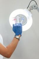 Close, up, view ,of cosmetologist hand that is holding syringes for injection lips augmentation photo