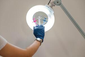 Close up view of cosmetologist ,hand that is holding syringes for injection lips augmentation photo